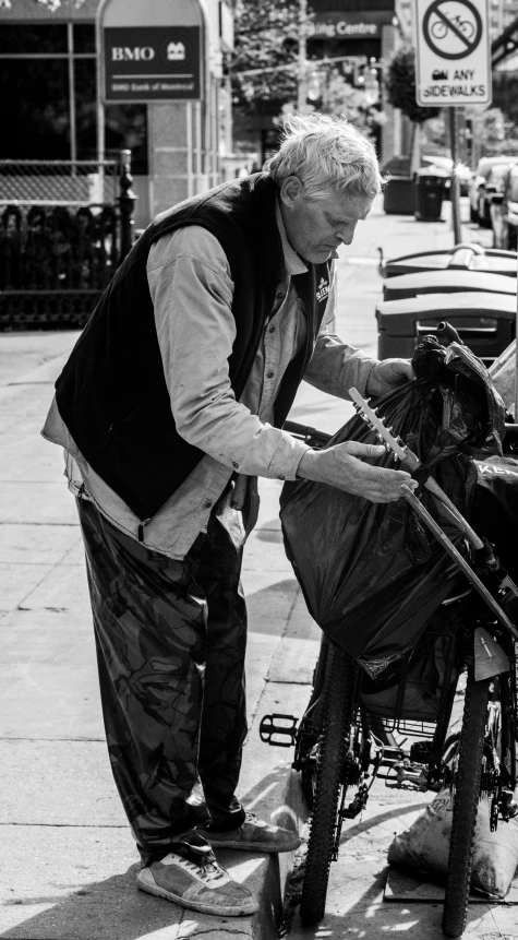 an older man with grey hair is fixing his old baby carriage