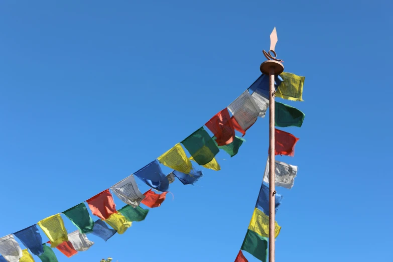 a pole that has several different colored flags in it