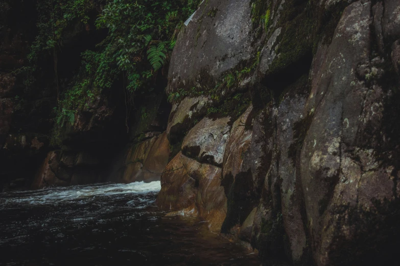 a waterfall is located next to a rock formation