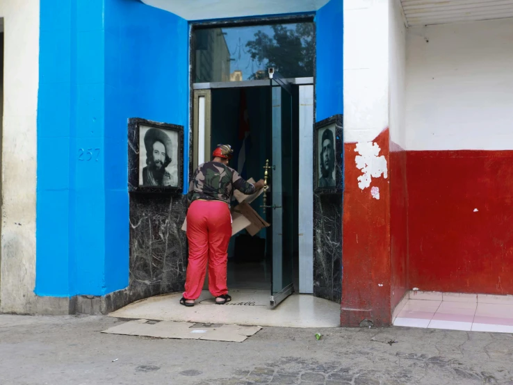 the two people are entering the blue and white building