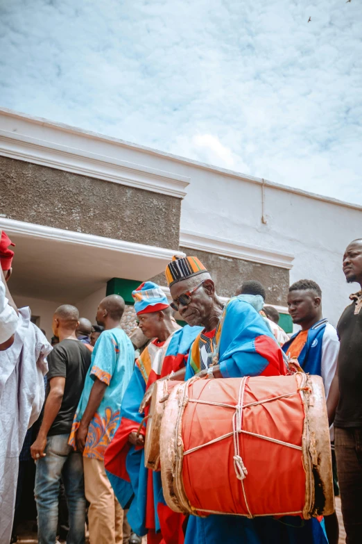 a group of people are gathered around a bag