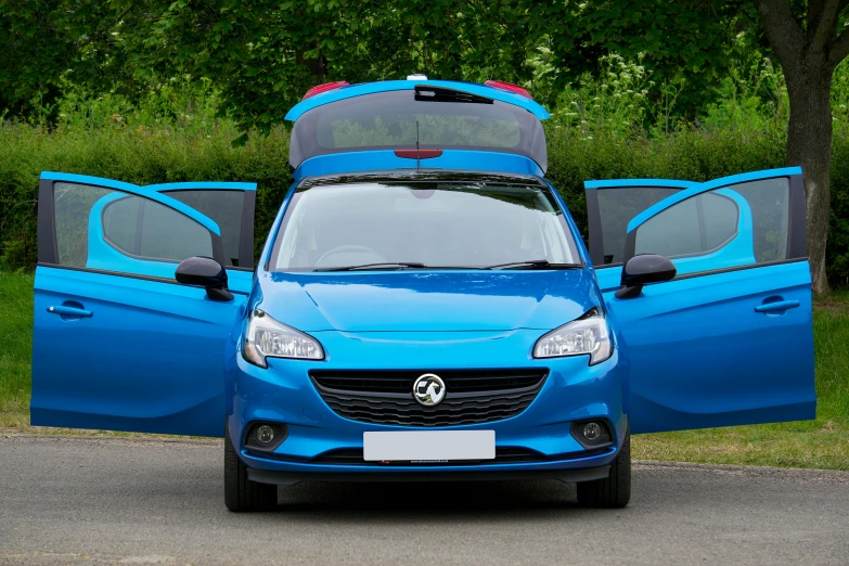 the back of a small blue van with its doors open