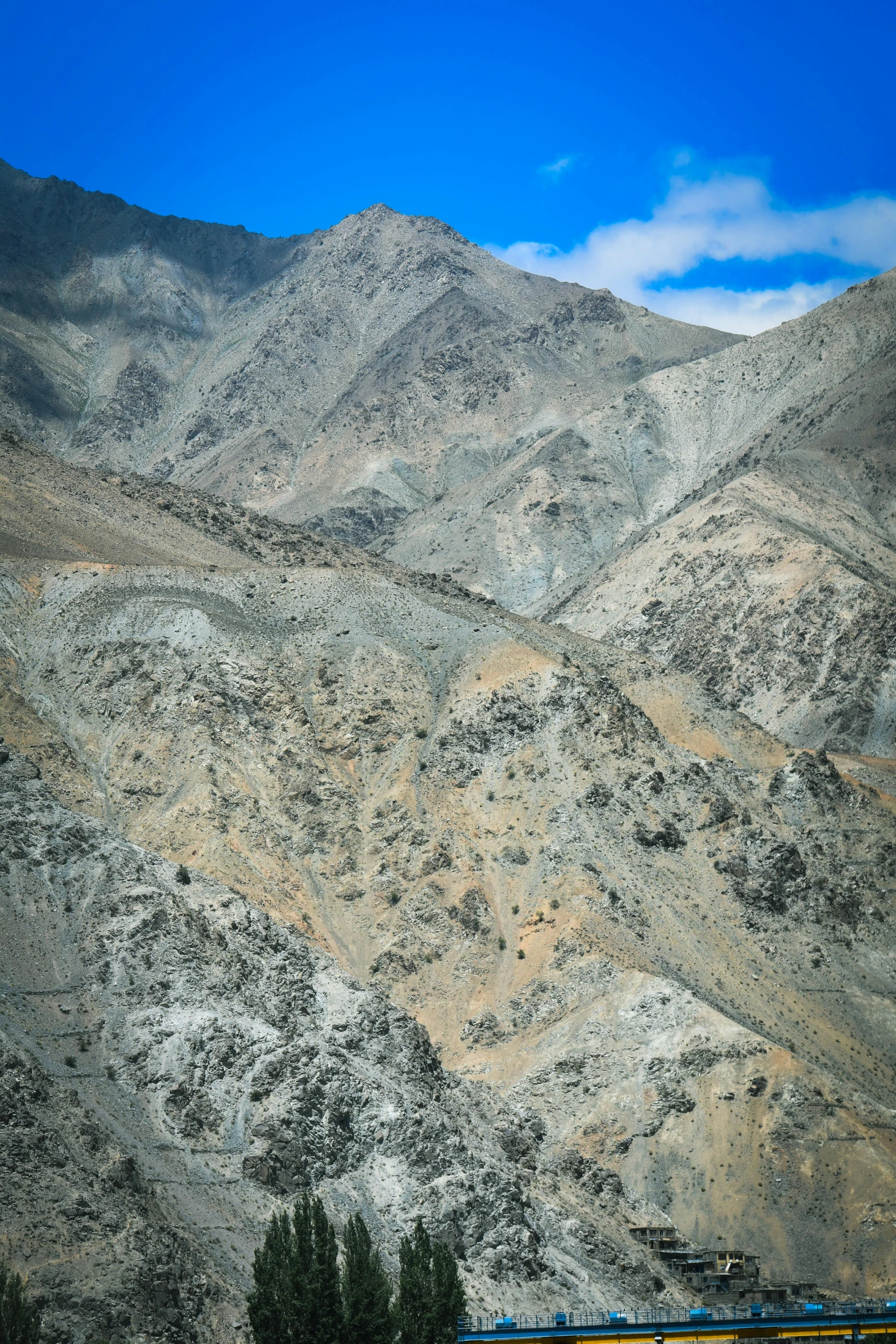 a train traveling on the tracks through mountains