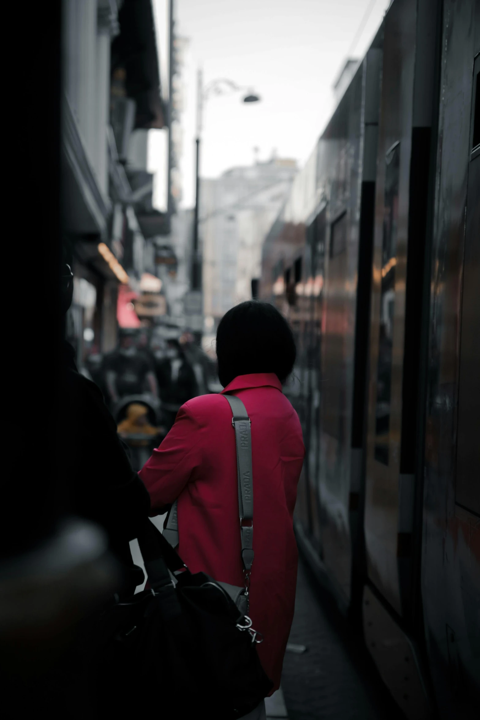 a man with a bag walking past a train