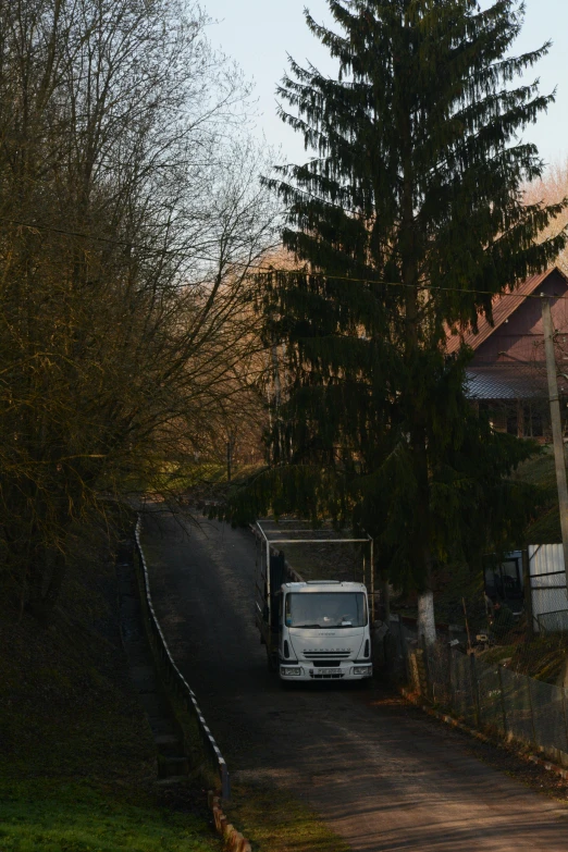 a white truck is driving down the road