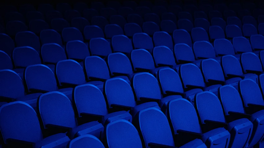 chairs and lights sitting in a large blue arena