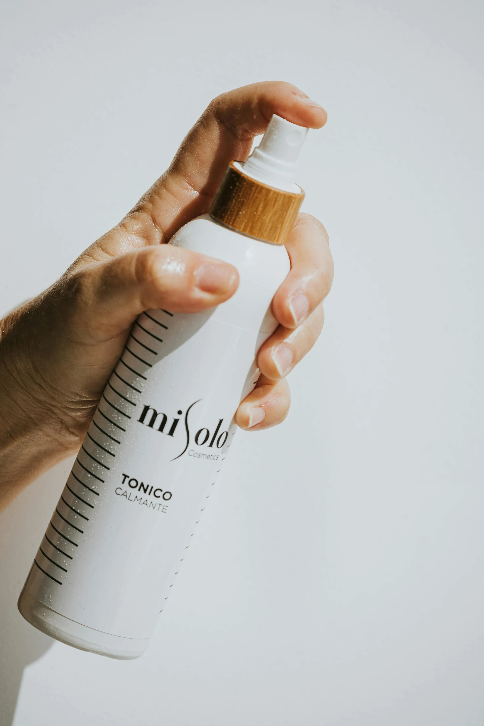 a person's hand holding a tube of white foam in a plastic container