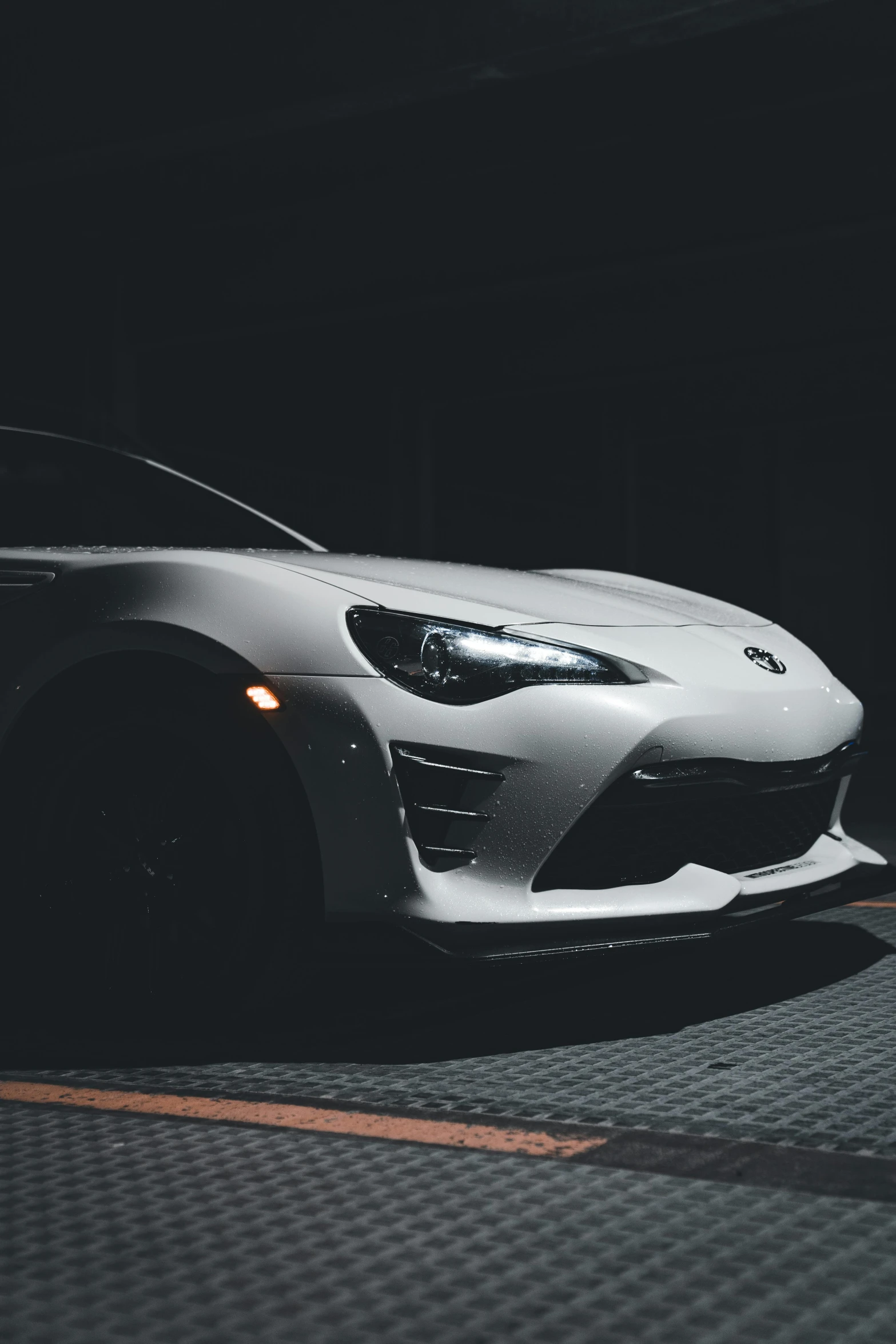 an abstract pograph of a white sports car in a darkened garage