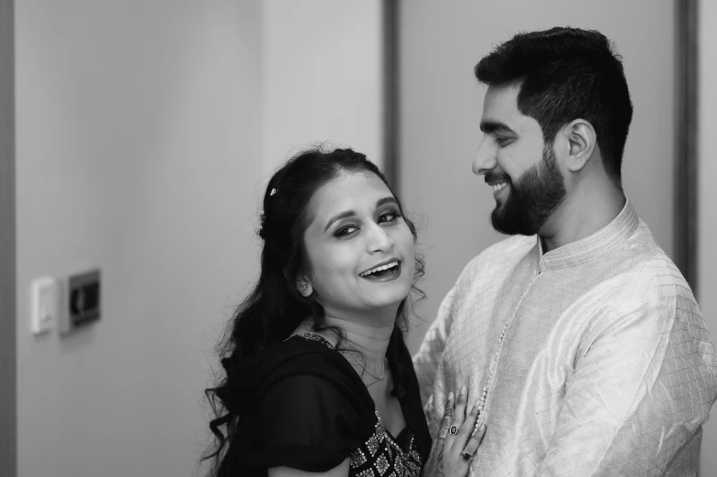 a young couple in the bathroom posing for the camera