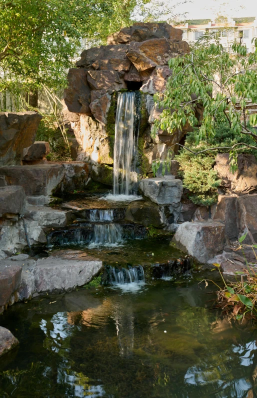 a large pond with a waterfall running into it