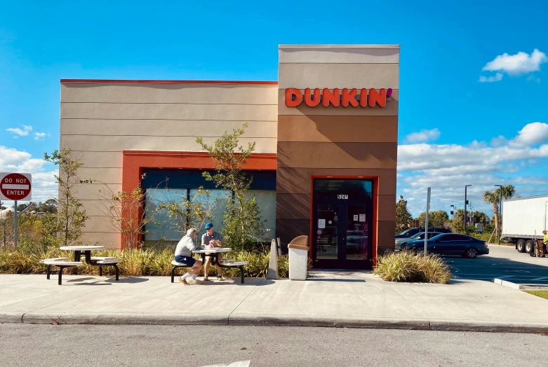 a store front with a sign outside the door