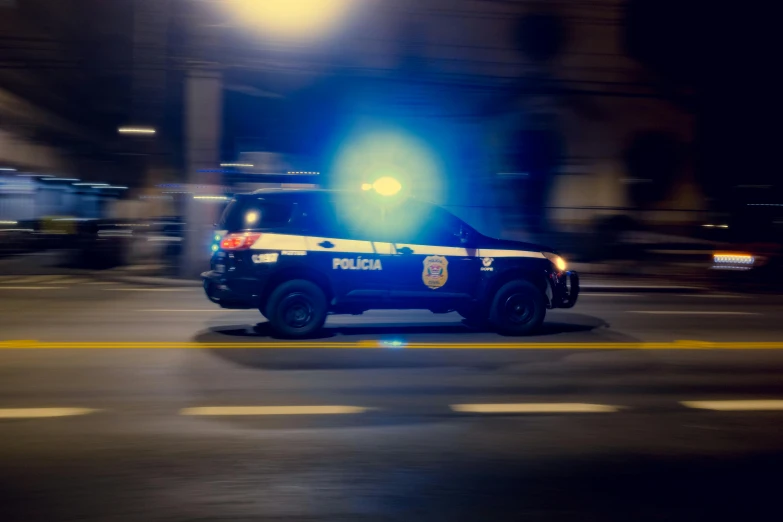 a police car stopped on a street at night time