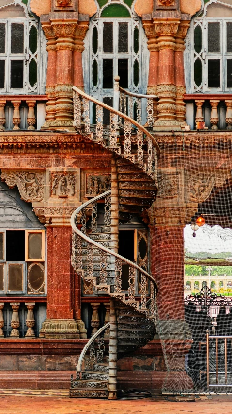 a spiral staircase leading up to some windows