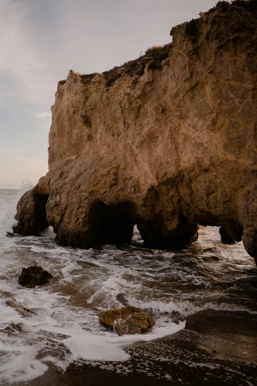 waves on the beach crashing against the cliffs