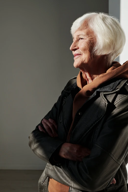 an old man with white hair wearing a black jacket