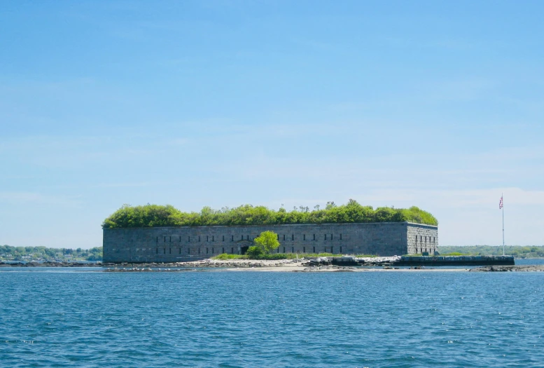 the island is off in the distance with a house on it