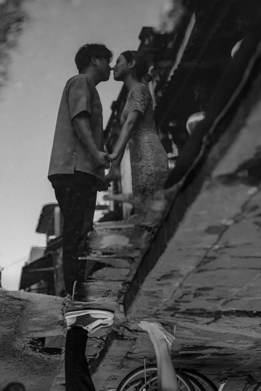 two people holding hands and standing by water