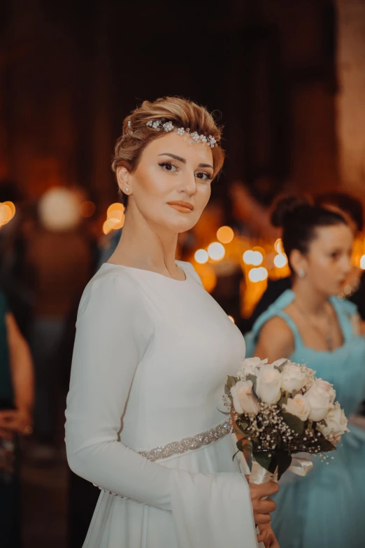 a beautiful bride standing in front of others