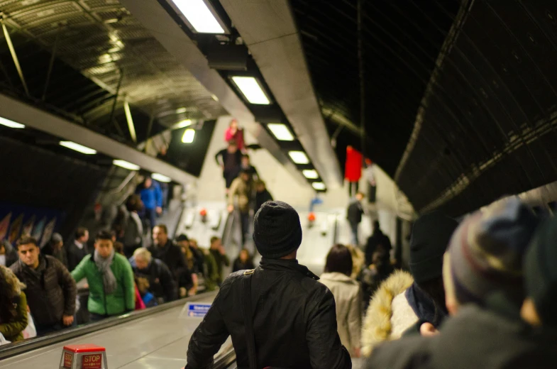 a crowd of people on an escalator