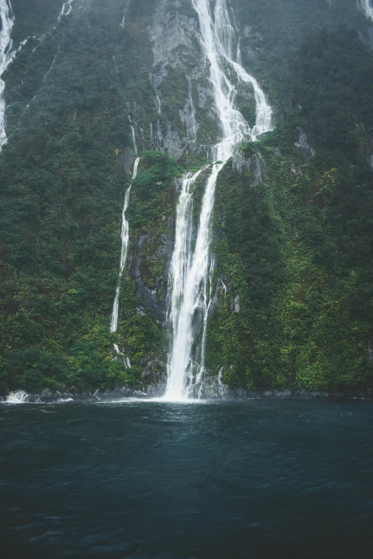 waterfall surrounded by lush green forest in ocean