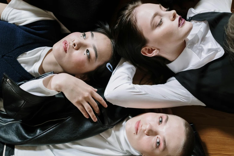 three women lay on the ground in a top down pograph