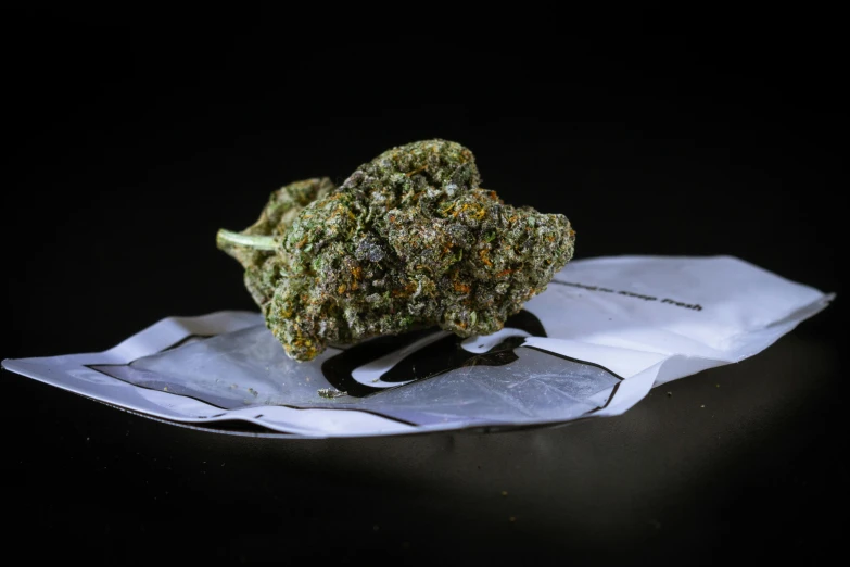 a marijuana weed on a napkin on a table