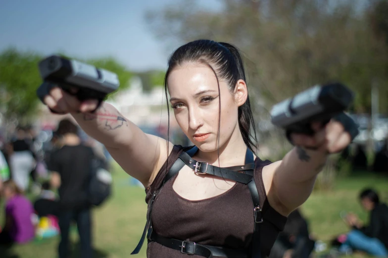 a woman has an electric gun with her hand out