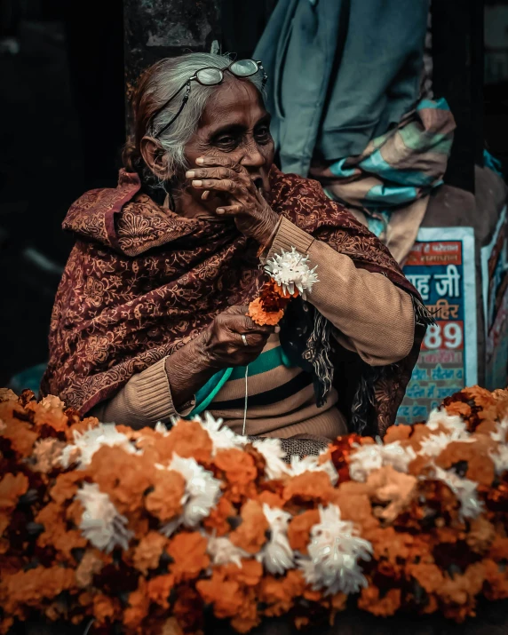 a women who is wearing a shawl and posing for a picture