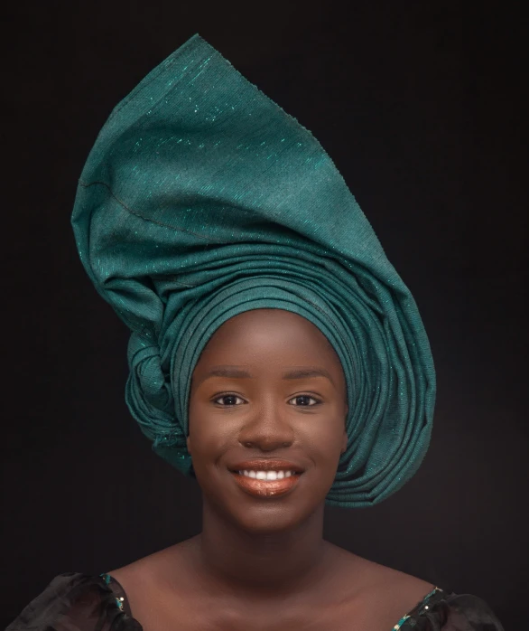 a woman with a green towel on her head