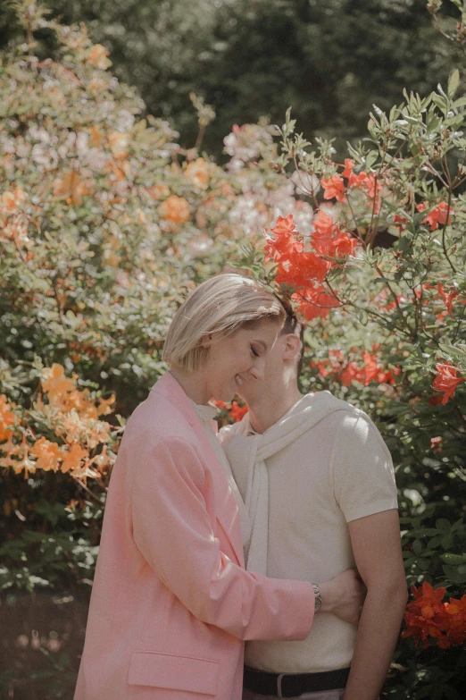 an older lady with white hair and a younger lady in pink looking at each other