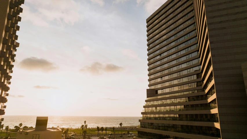 two buildings overlooking a city by the water