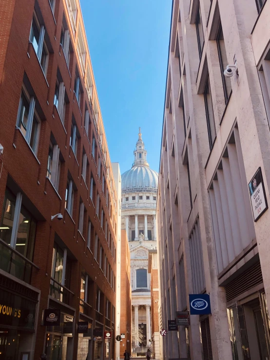 a street with a building and another building on the corner