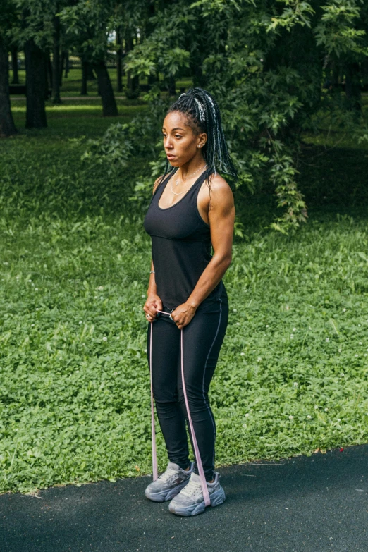 an african woman stands with her walking poles in front of a field