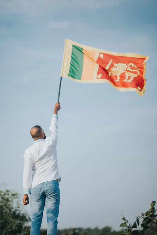 a man waves a flag in the sky