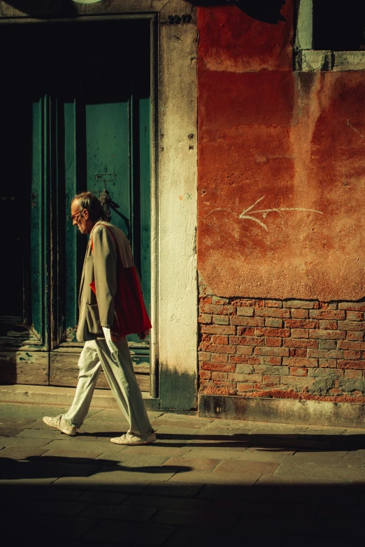 a man walks down the street with his foot on a sidewalk