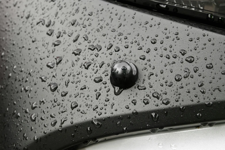 a black and white po shows the rain on a car