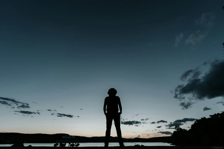 a woman standing on top of a sandy beach