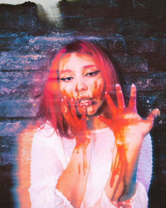 a woman with paint all over her face and hands