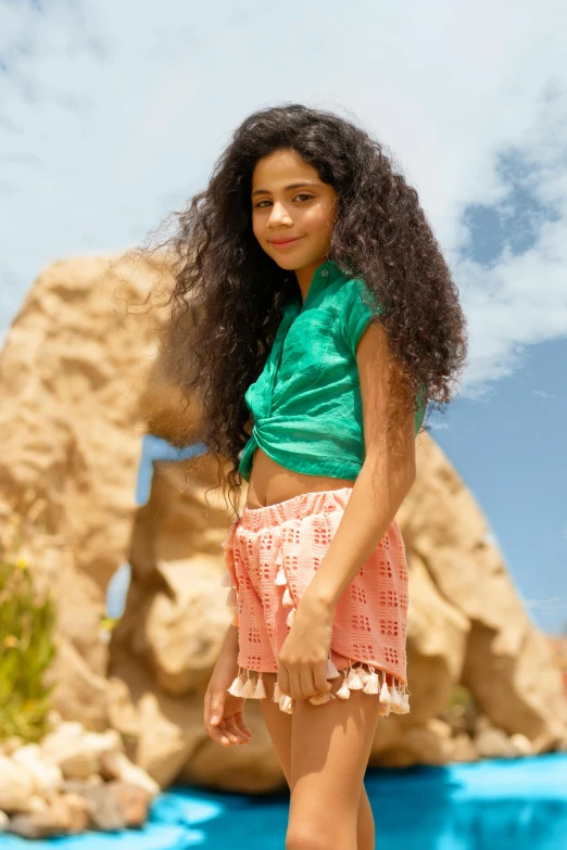 a girl is standing with her hair hanging out