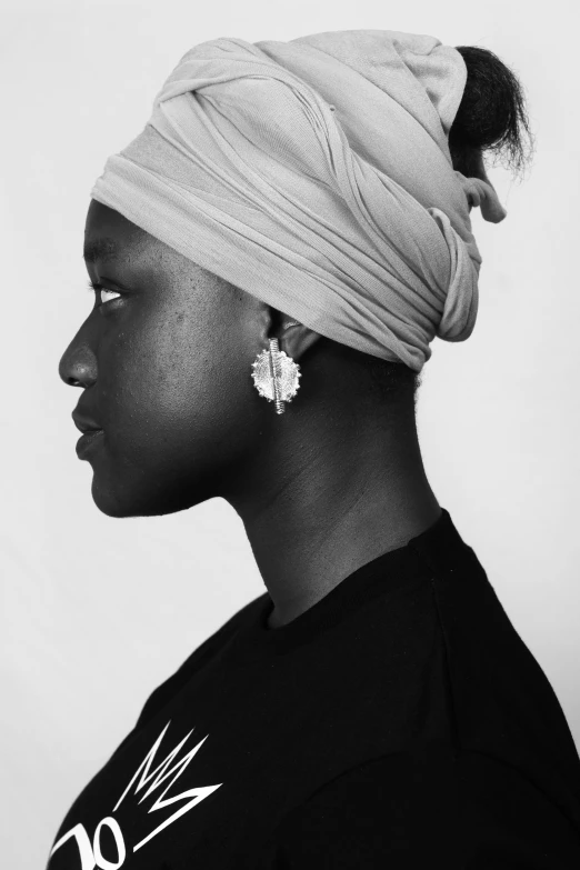 a woman in black and white wearing a turban