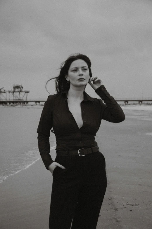 the woman is posing on the beach for a po