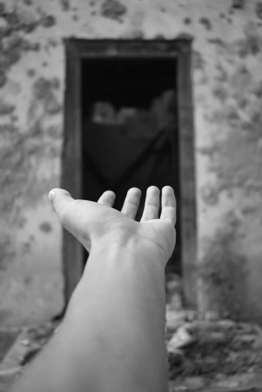 the hand has raised up out to touch a window