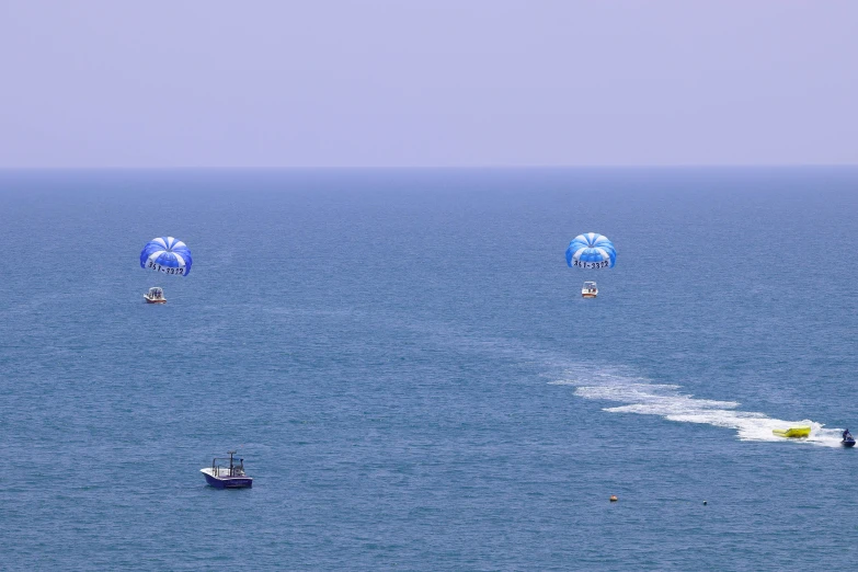 a group of people para sailing across the ocean