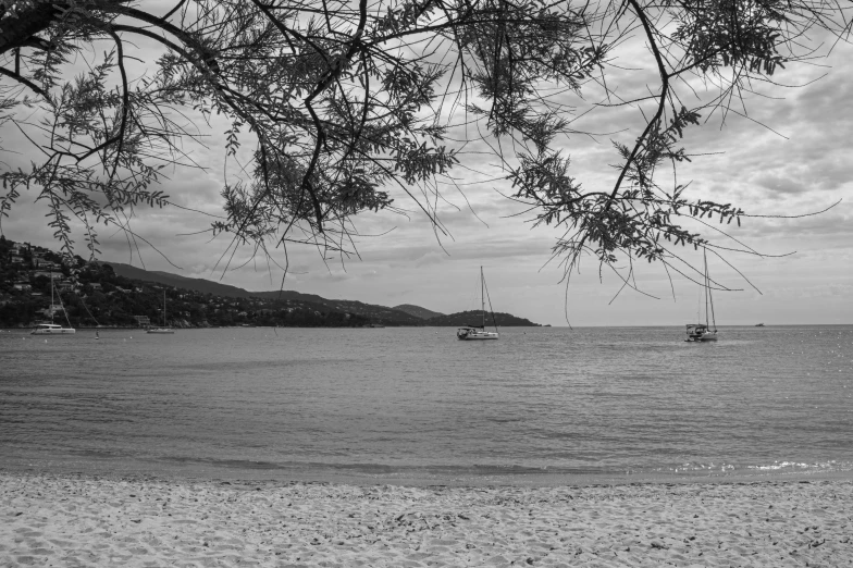 the view from the beach with two boats on it