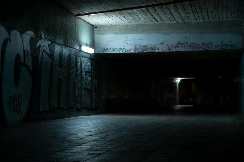 dark room with graffiti on the walls and lights on