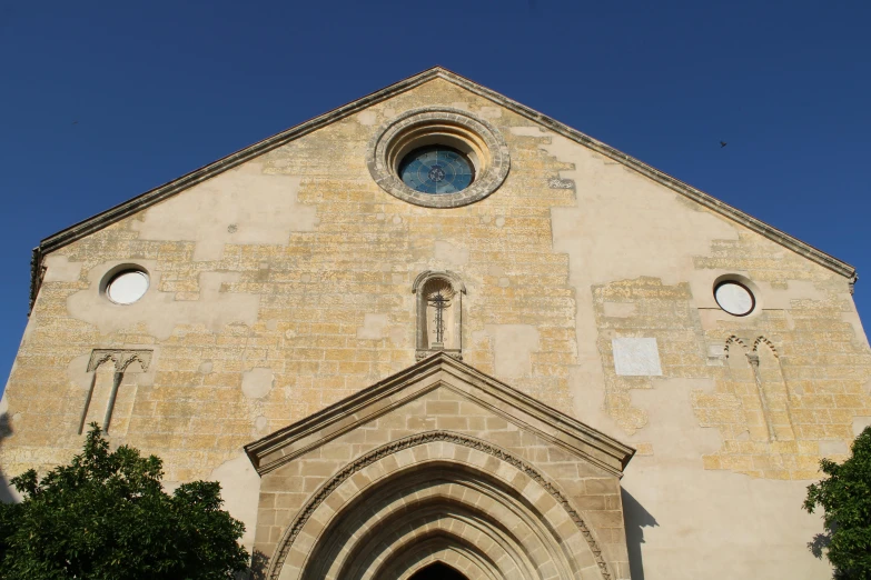 an old church with three windows is shown