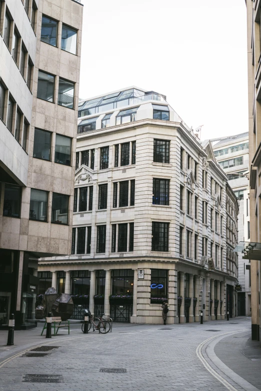 an empty city street with buildings in the background