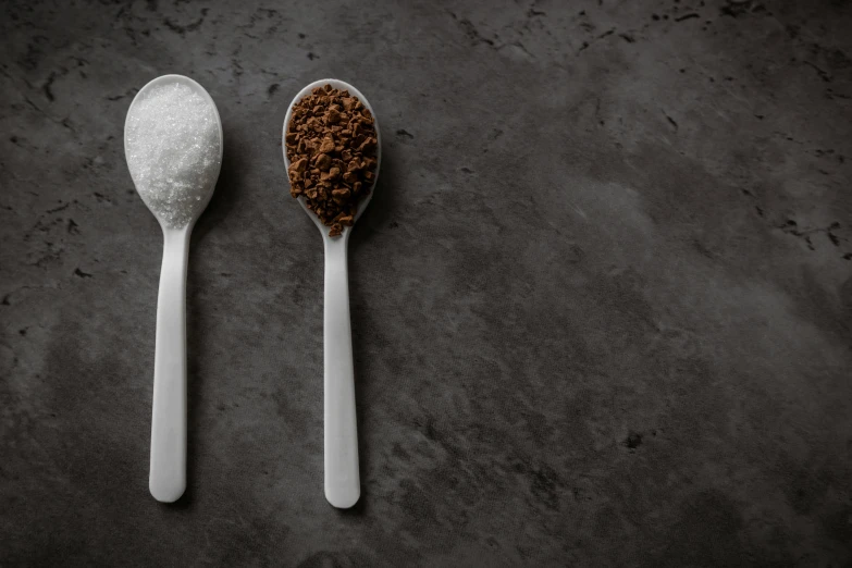 two spoons with different sized cereal on them