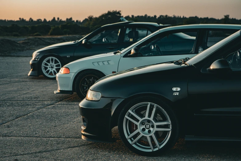 two black and white cars parked in a parking lot