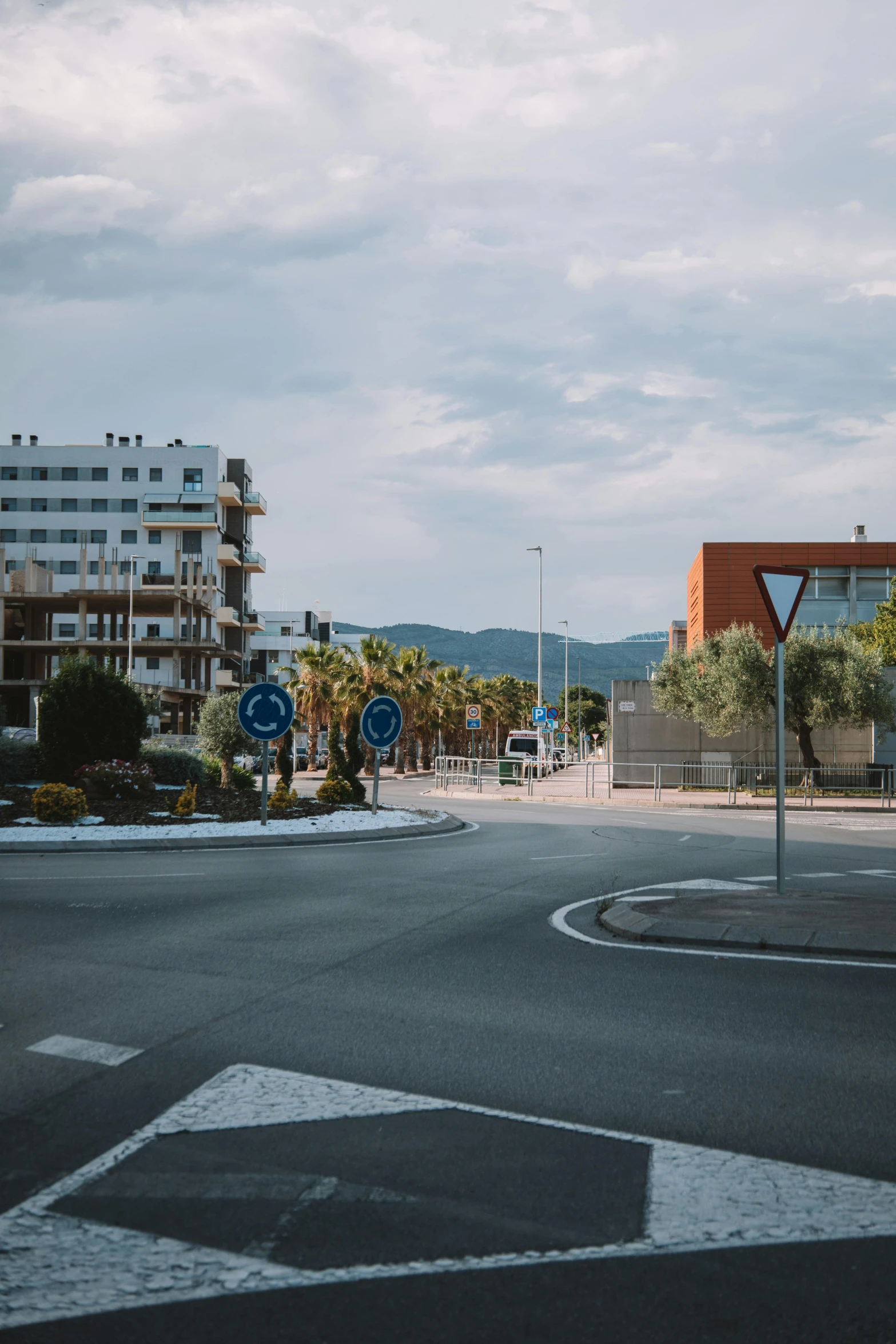 a city street with a large building in the distance